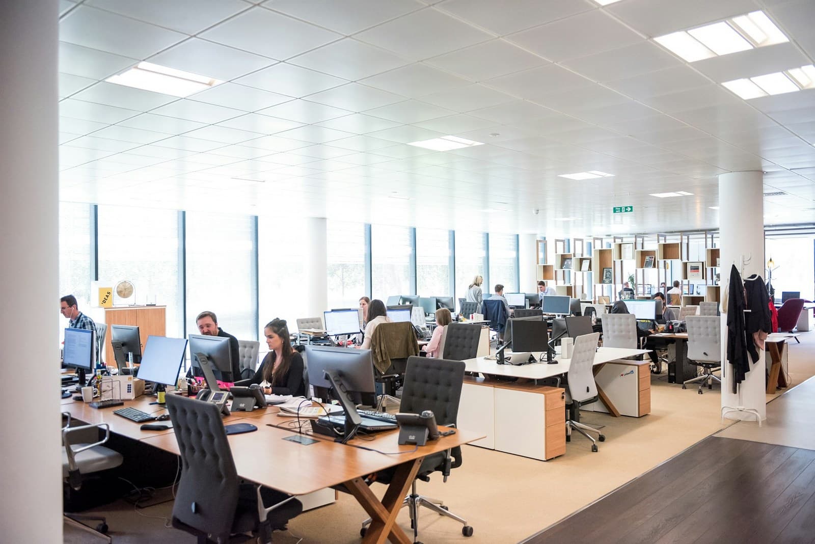 Corporate sales floor with rows of headsets and monitors