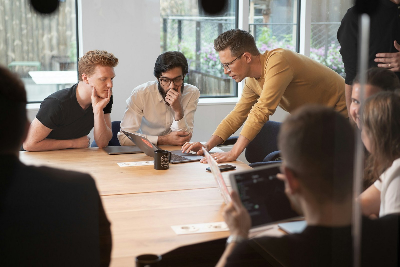 Marketing team in a tense meeting disagreeing over conflicting attribution numbers